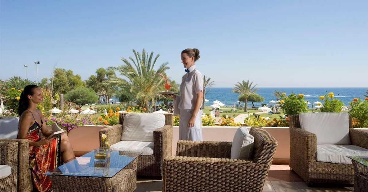 Een foto van het terras bij Constantinou Bros Athena Royal Beach Hotel