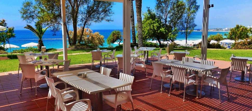 Een foto van het terras bij Grecian Sands Hotel