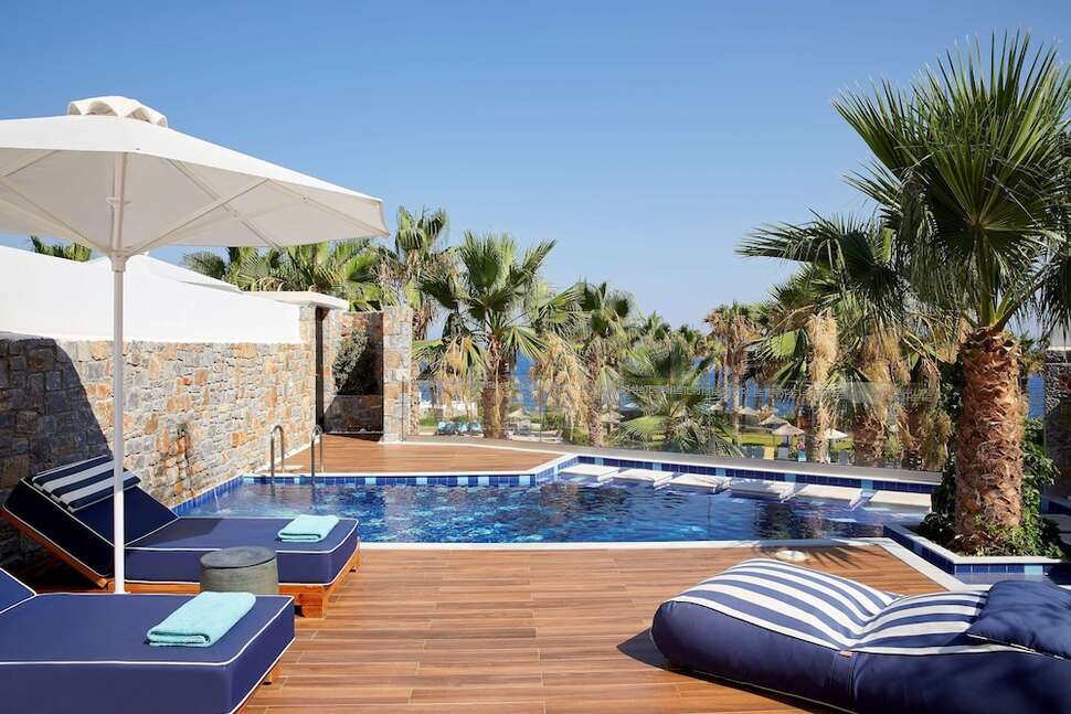 Een foto van het zwembad bij Minos Imperial Luxury Beach Resort & Spa